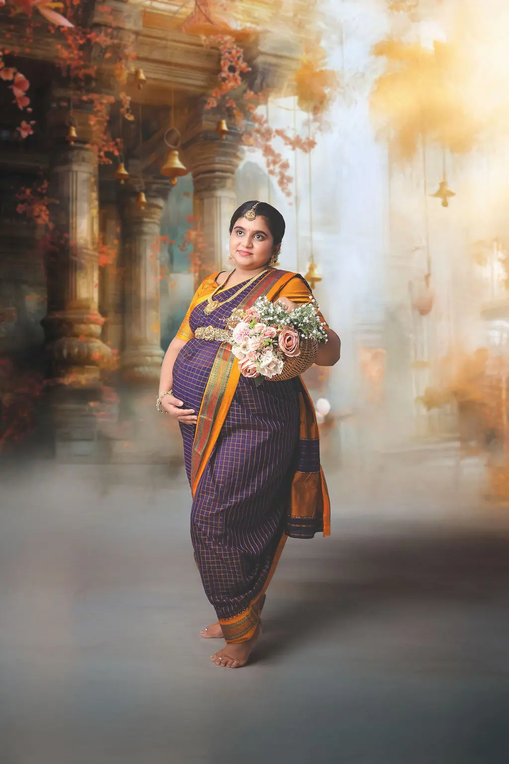 Expectant mother in a purple checked saree holding a basket of roses, painted temple backdrop, maternity photoshoot at WonderBump Studio, Bengaluru